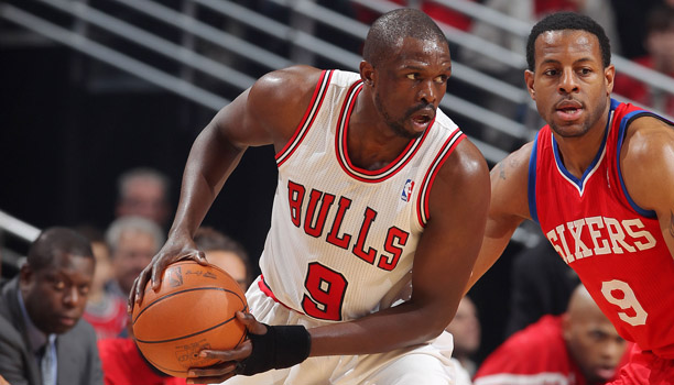 Chicago Bulls forward Luol Deng, center, gets a shot off between